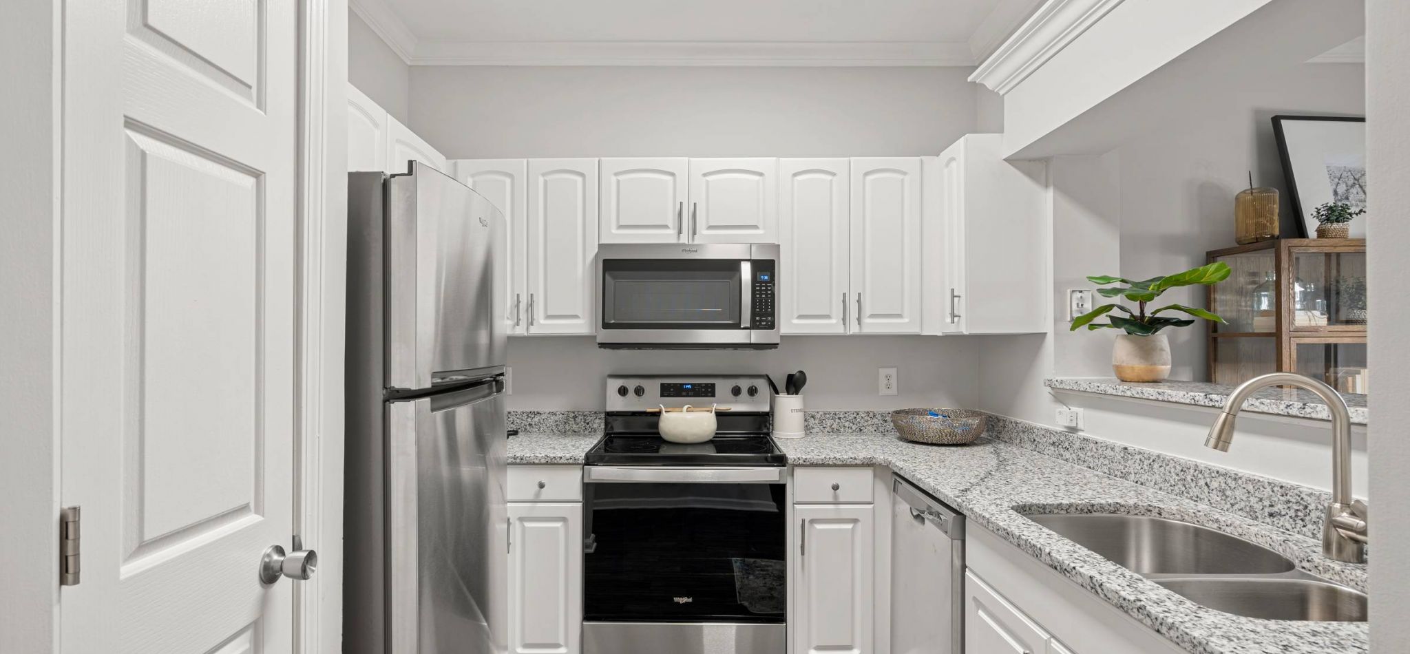 Hawthorne at the Carlyle apartment kitchen equipped with appliances and ample cabinet storage.