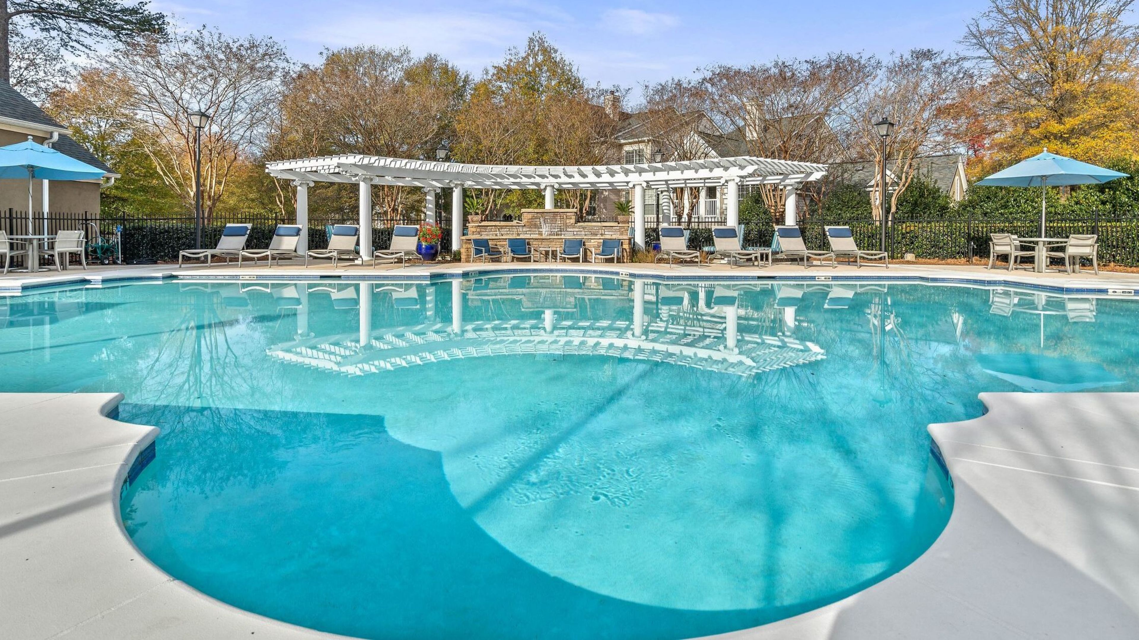 large pool amenity bordered by lounge chairs.