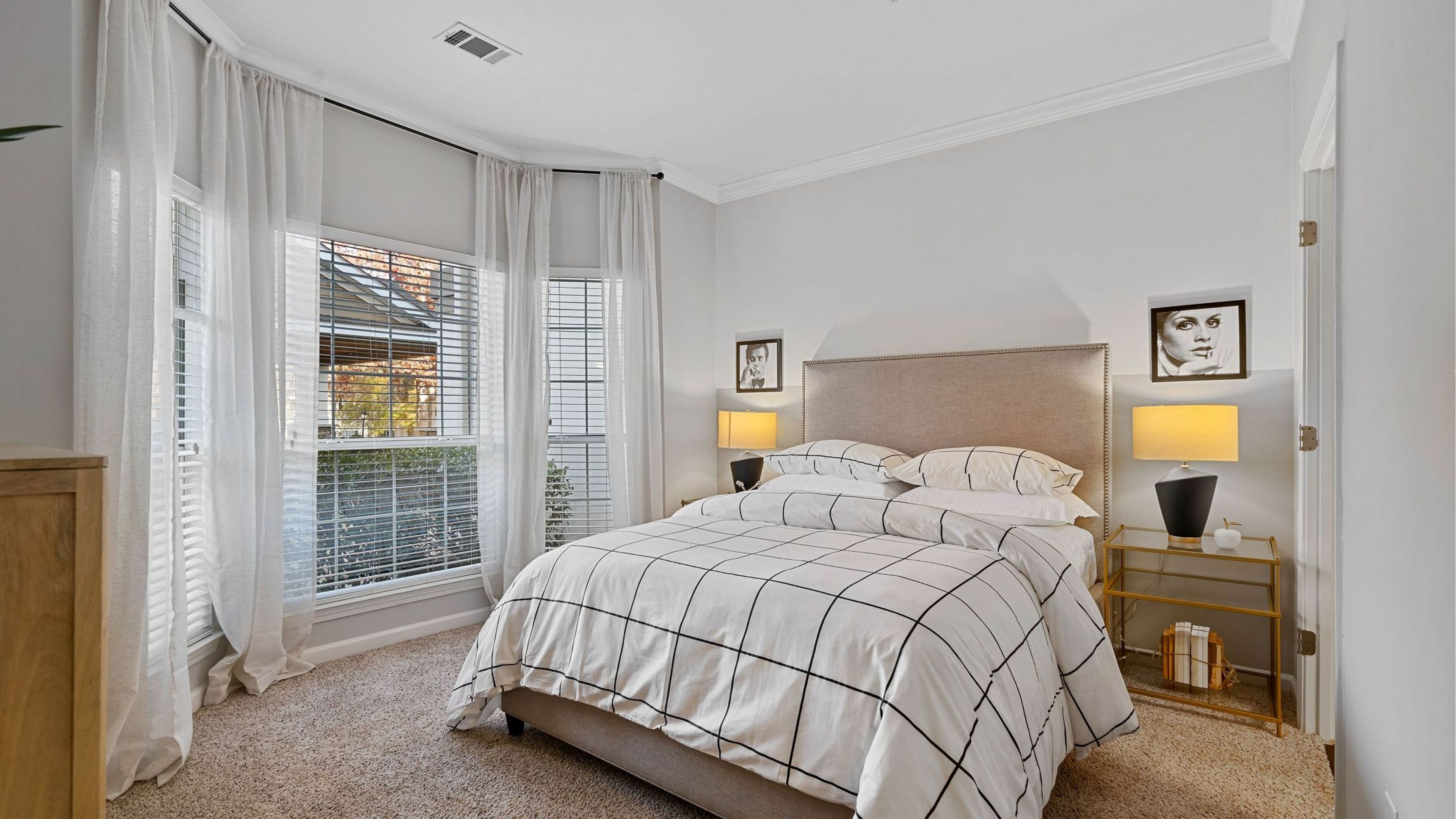 Hawthorne at the Carlyle spacious carpeted bedroom with large bay window with ample natural light.